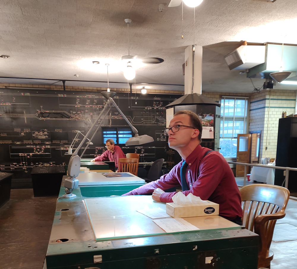 Two men at desks in power office