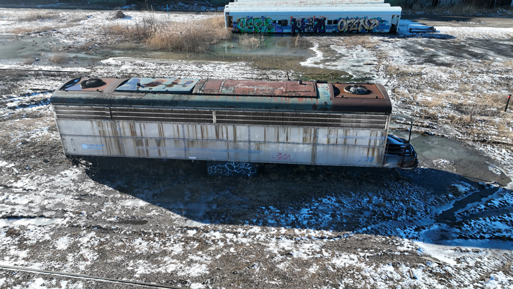 Aerial view of cabless, rusting former locomotive