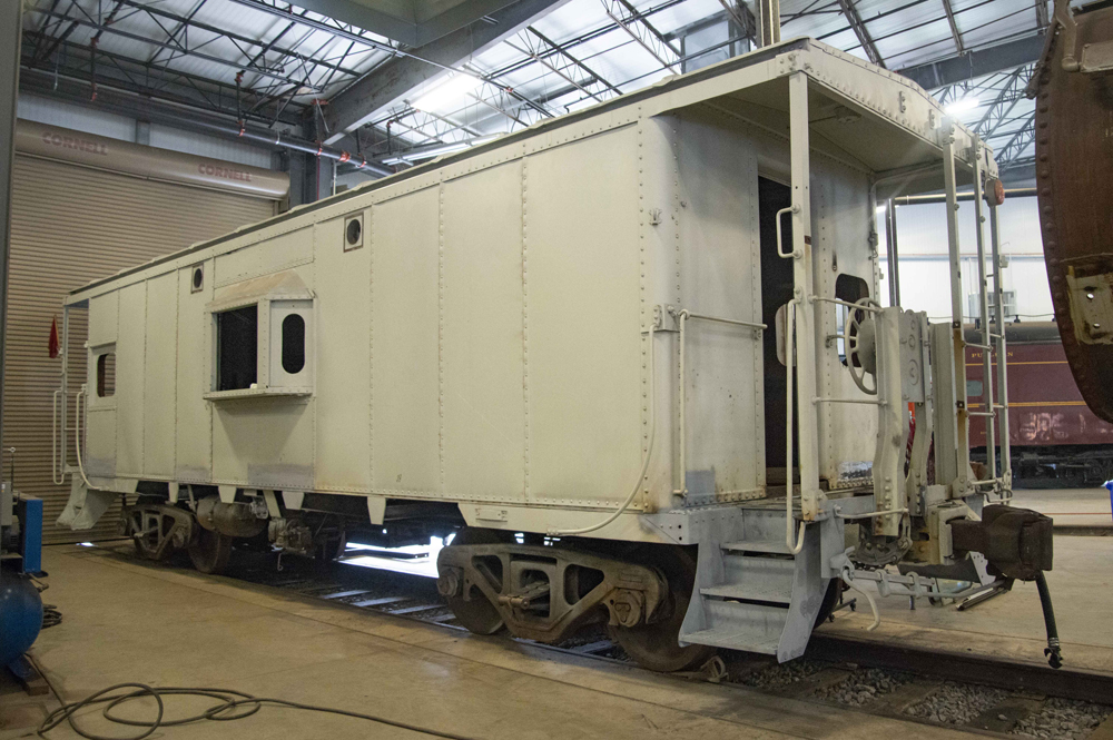 Caboose inside building in primer paint