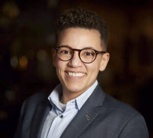 Woman with short hair and glasses