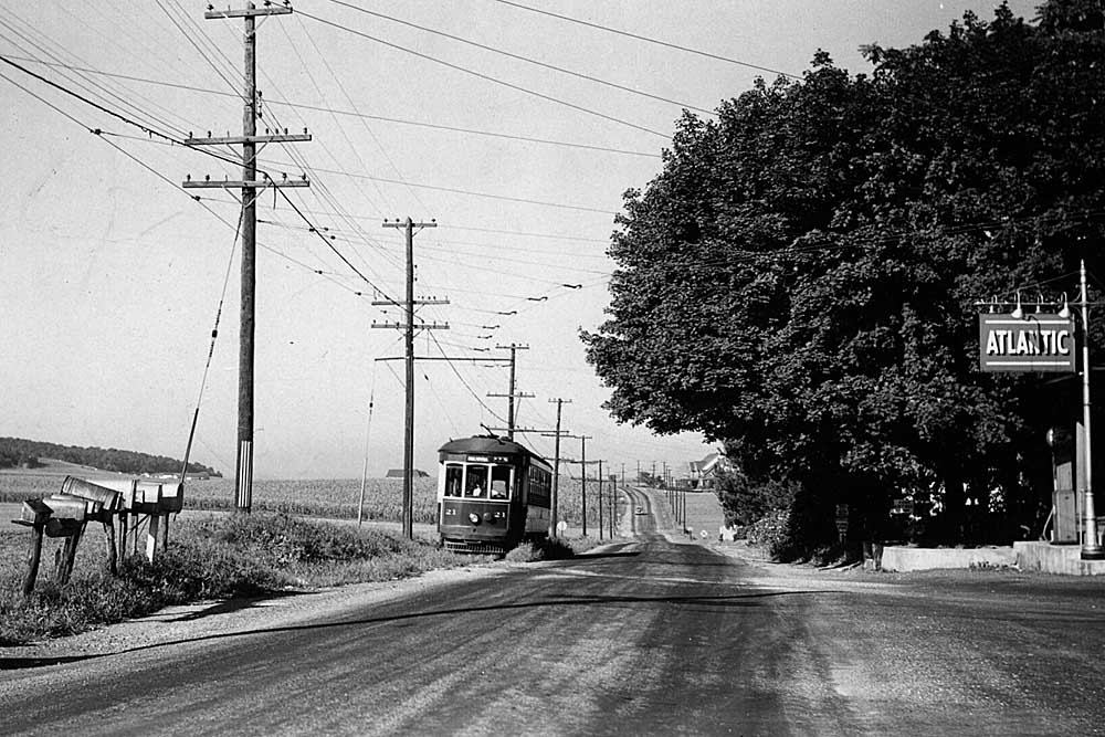 Trolley car running on rural roadside