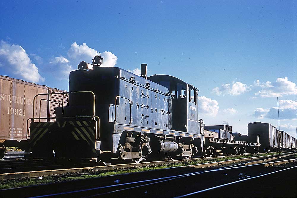 Black diesel Wabash locomotives with freight cars