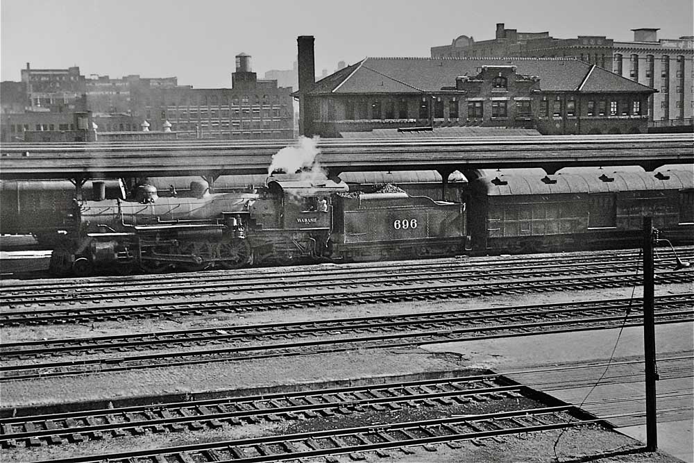 Steam Wabash locomotives with passenger train in city station