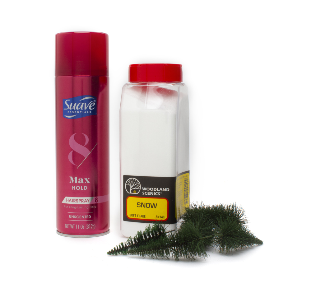 hairspray, model trees, and container of fake snow