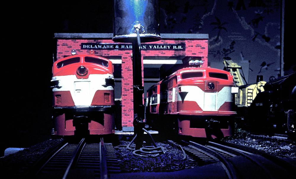 two red and white toy trains in vintage photo