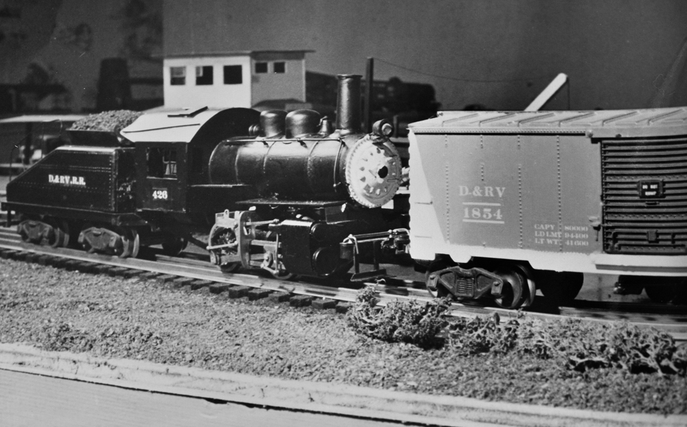 black and white photo with model steam engine