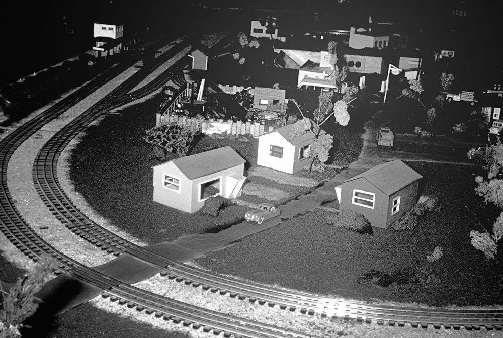 black and white photo of curves of track on toy train layout
