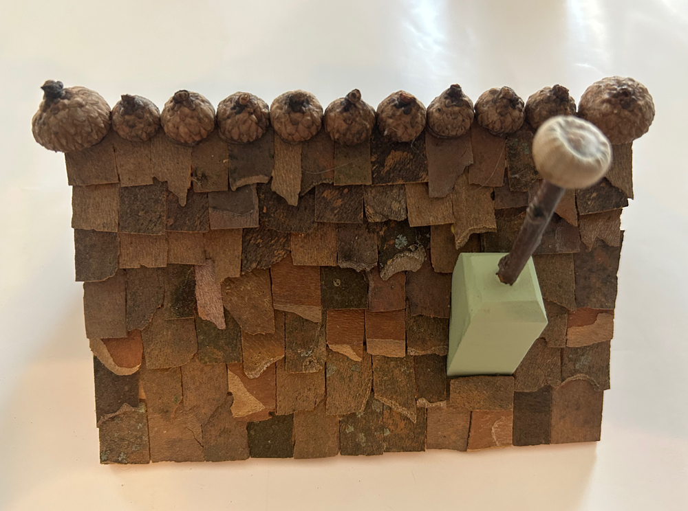 roof of fairy structure with bark and acorns