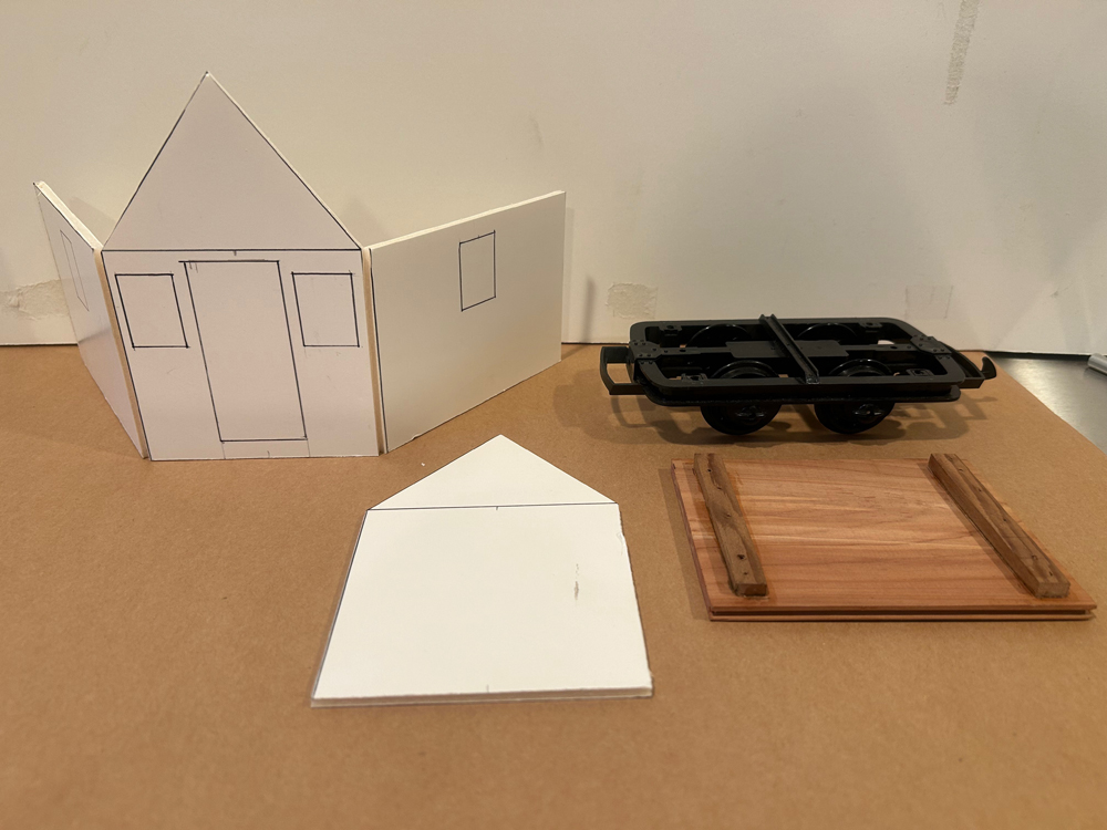 cut out pieces of foam board to look like a house