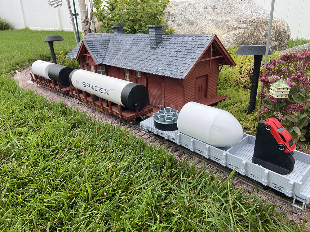 rocket sections on two flatcars on a garden railway