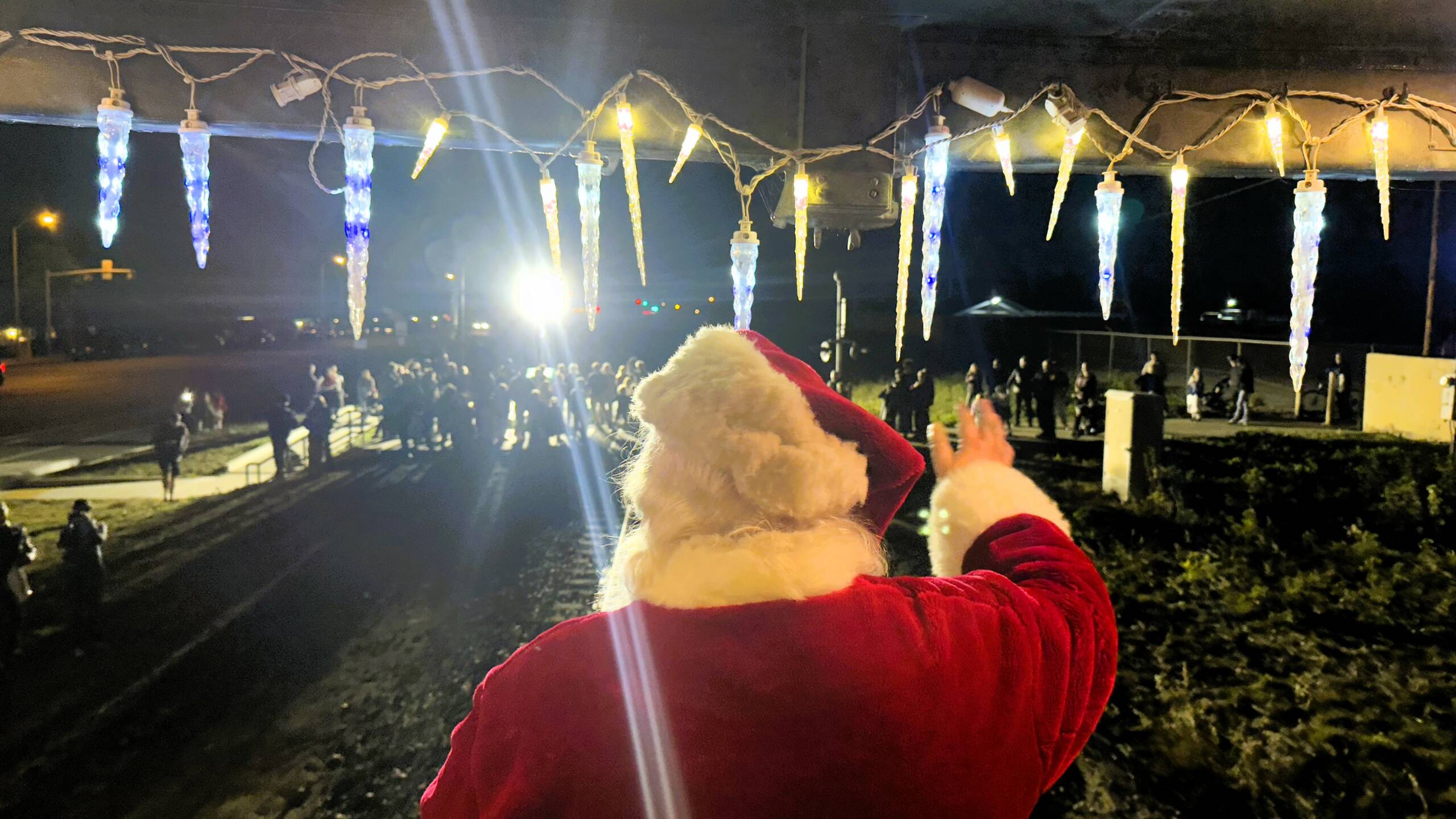 Santa waving from holiday decorated train