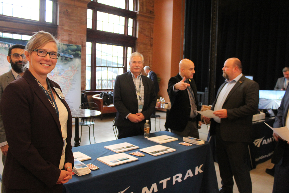 Group of people around table, with women nearest camera looking at photographer