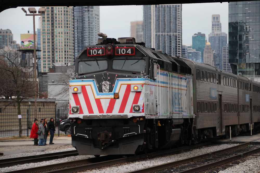 Predominantly white Metra unit in push mode