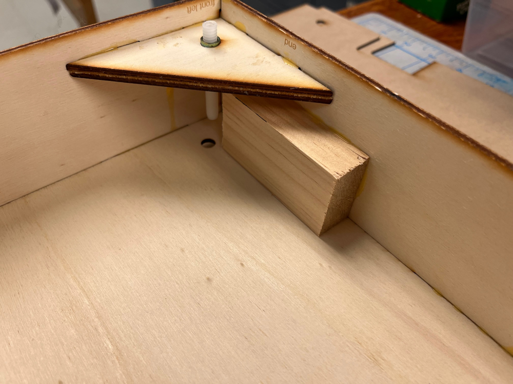 Wood block and triangle glued into a larger wood box.