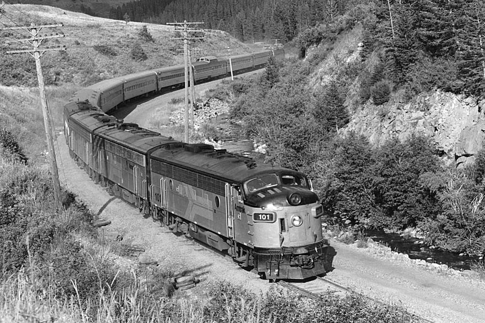 Streamlined Amtrak passenger train on curve in mountains