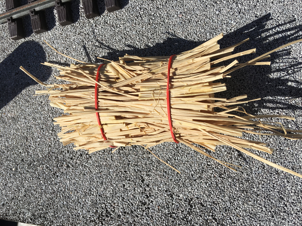 straw with rubber bands wrapped around it