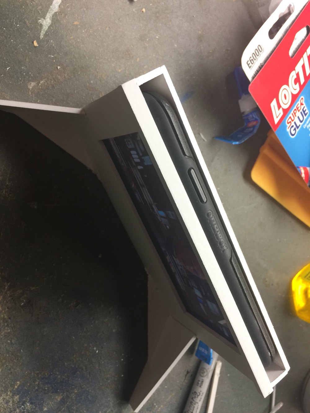 A smartphone inside a styrene enclosure