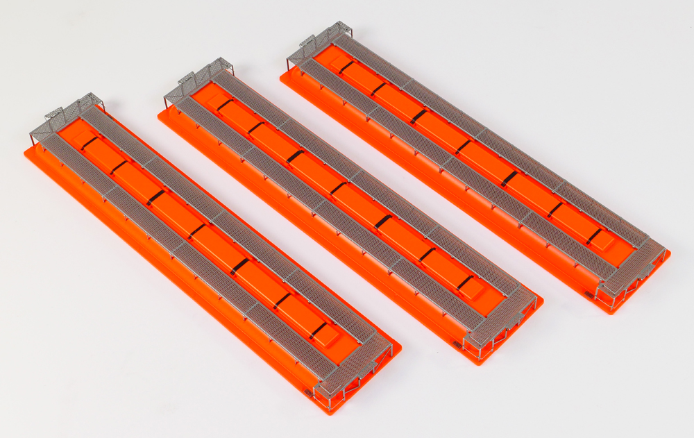 Color photo of three hopper toppers painted orange.