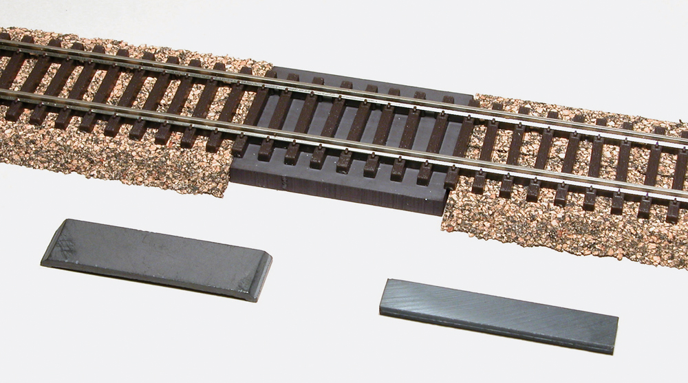 Photo with HO scale track, cork roadbed, and three magnets.
