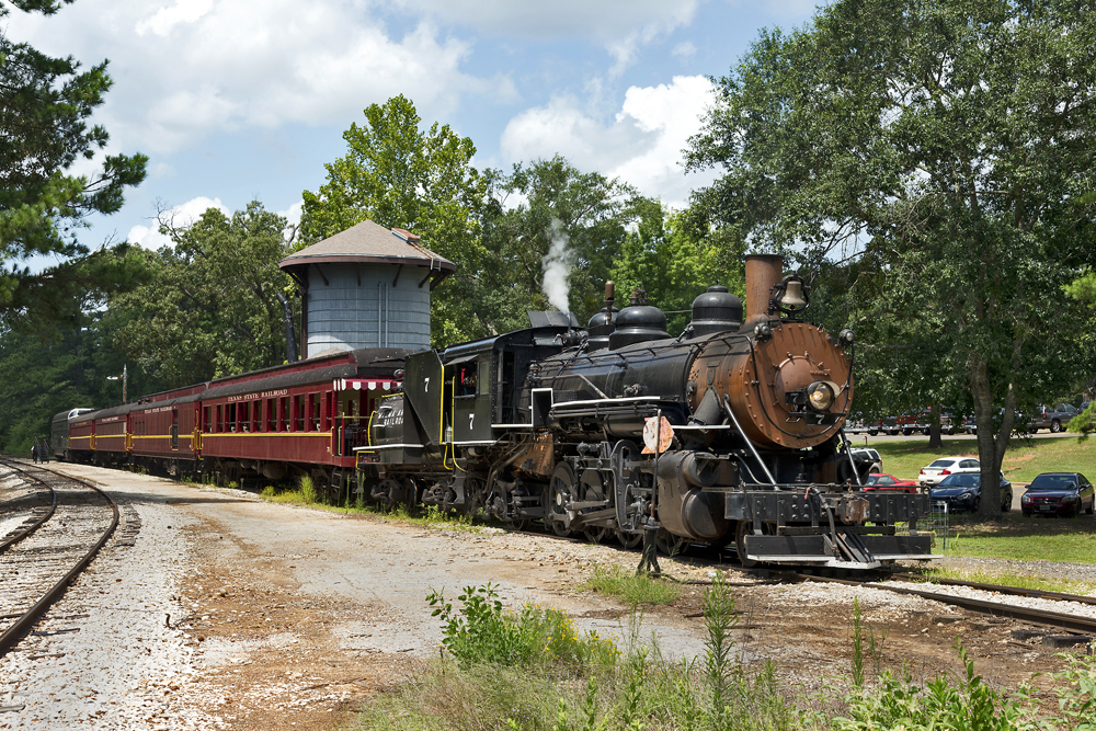 steam train on railroad on a sunny day