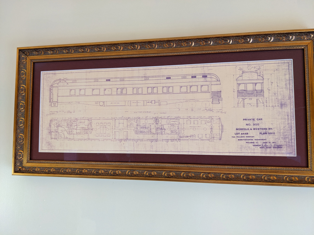 A framed drawing of a private passenger car.