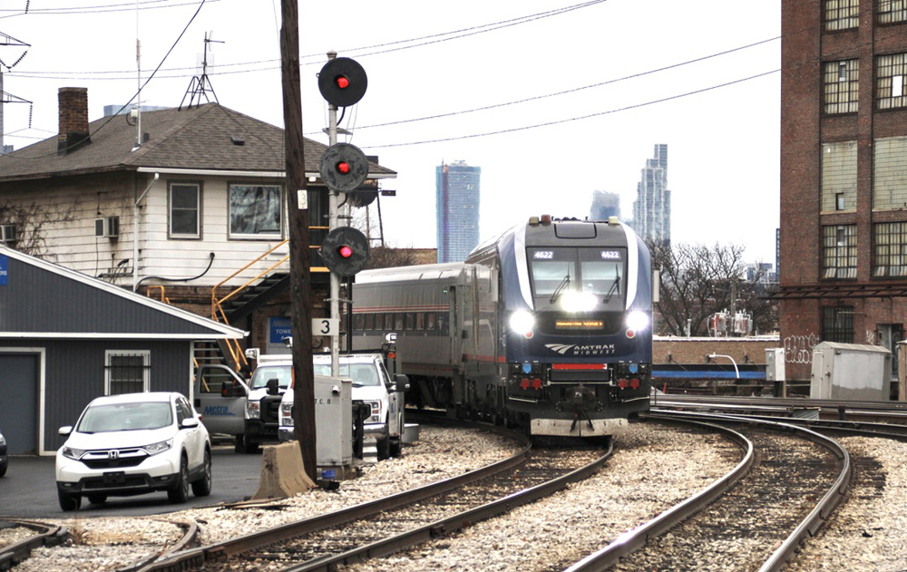 Passenger train on curve next to tower