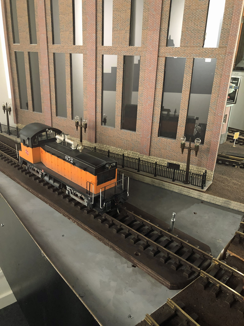 close up of model track with black and orange locomotive