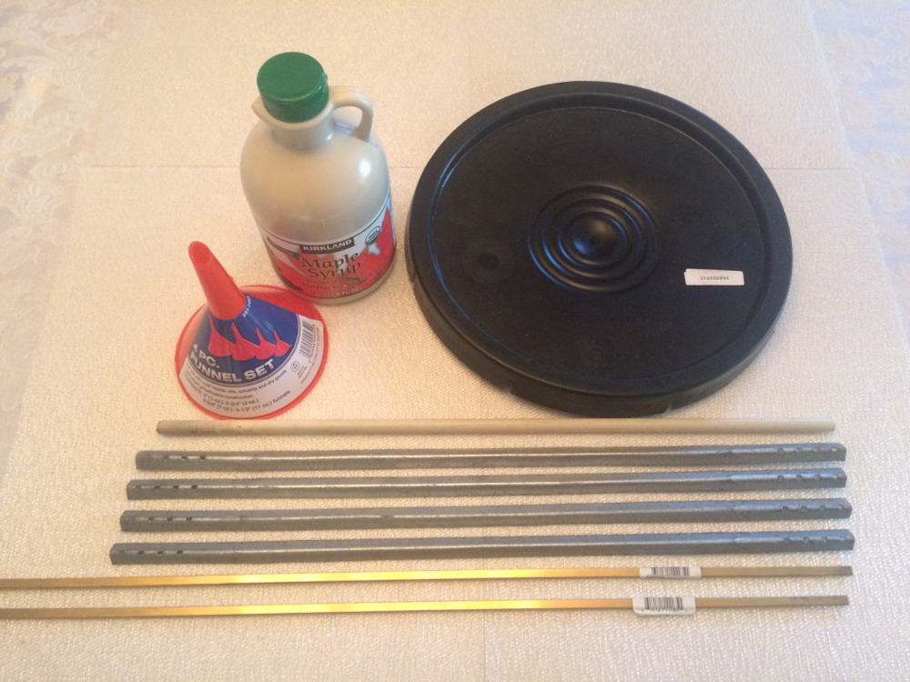 jug of syrup, funnel, metal rods, and lid