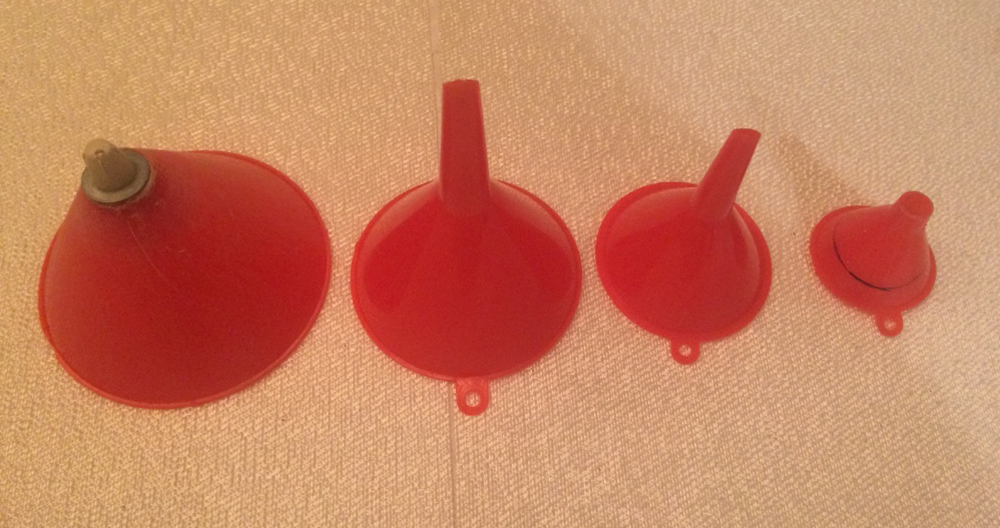 four red plastic funnels