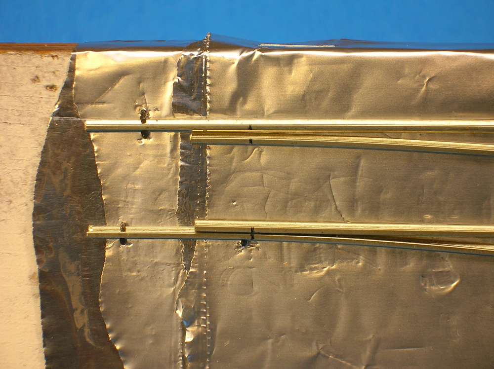 The points of a turnout coming to the stock rails, both marked so they seat properly