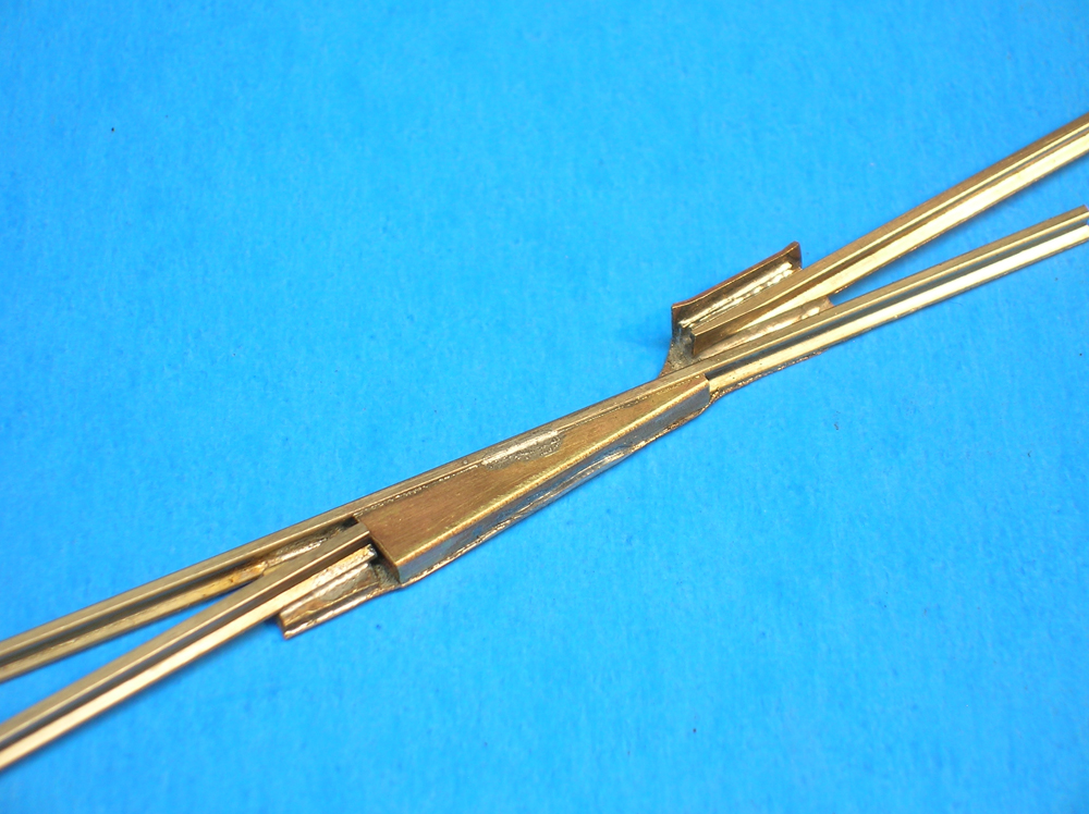 A completed model railroad lift-frog sits on a blue background