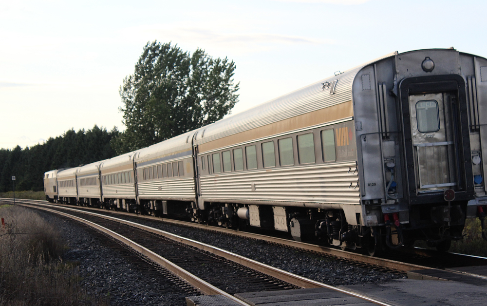 Passenger train on curve moving away from photographer