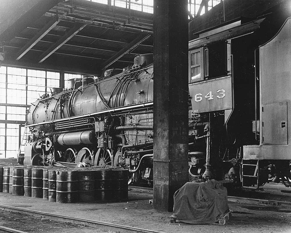 Rear of steam locomotive inside shop building