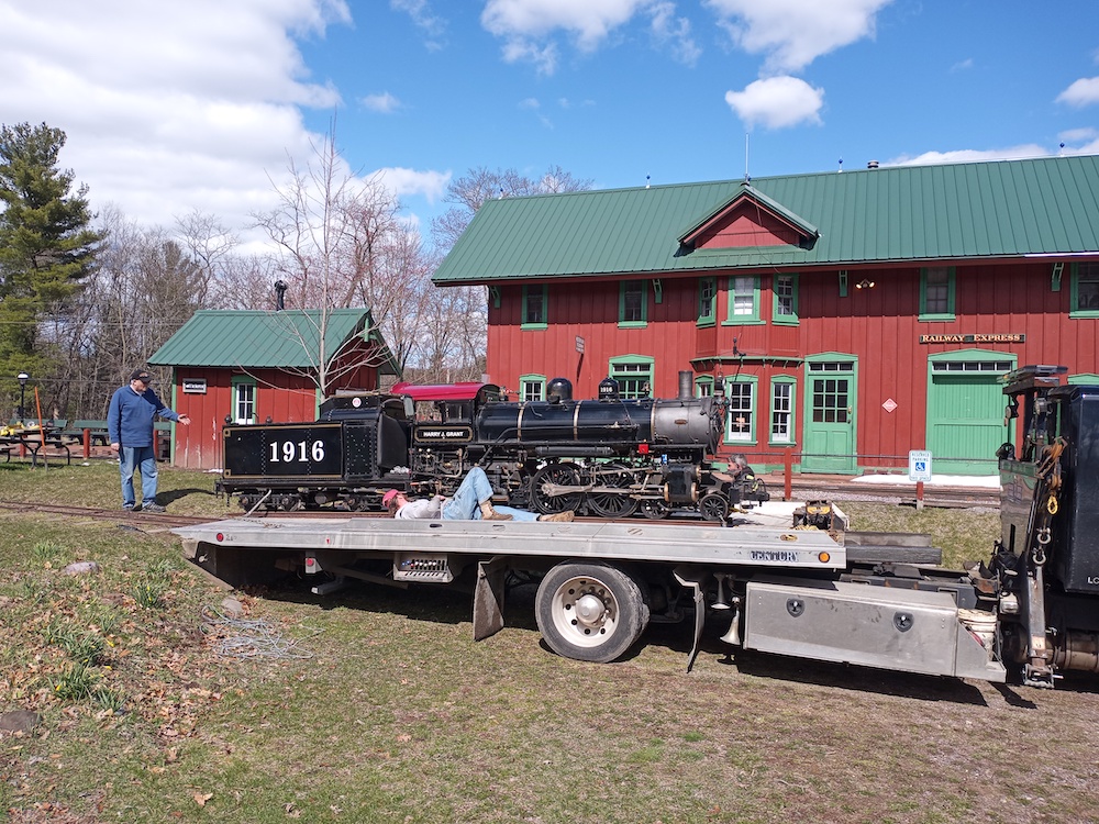 The Little steam locomotive being unloaded from a trailer.