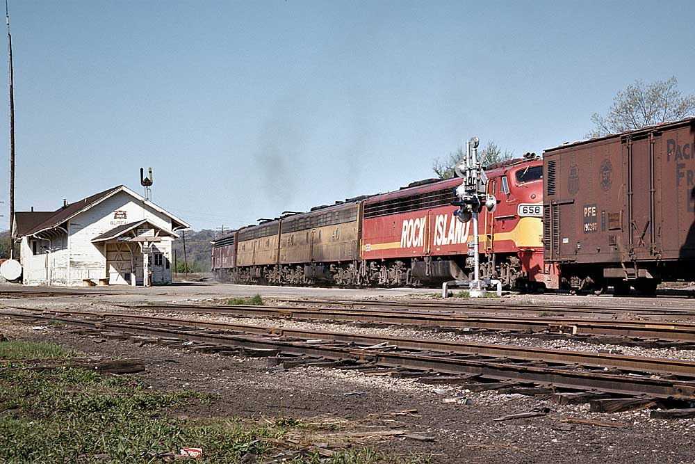 Red-and-yellow diesel Rock Island locomotives on freight train
