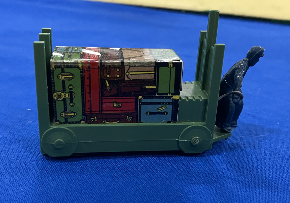 baggage cart on blue table