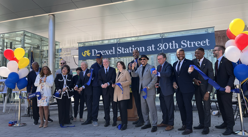 15 people with blue ribbon and balloons
