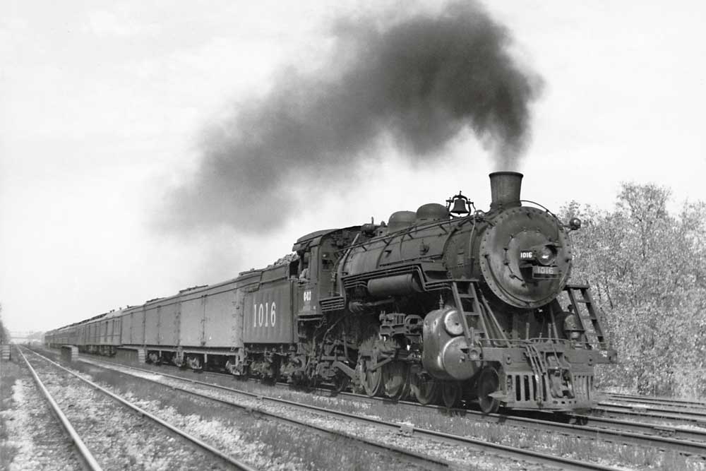 Smoking steam locomotive with passenger train