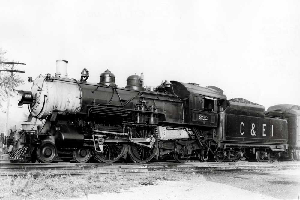Steam locomotive in profile with passenger train
