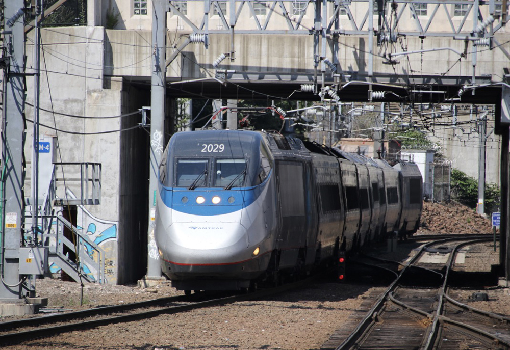 Acela trainset passing under street bridge