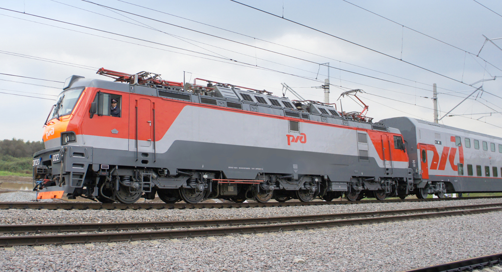 Gray and orange locomotive and bilevel passenger car