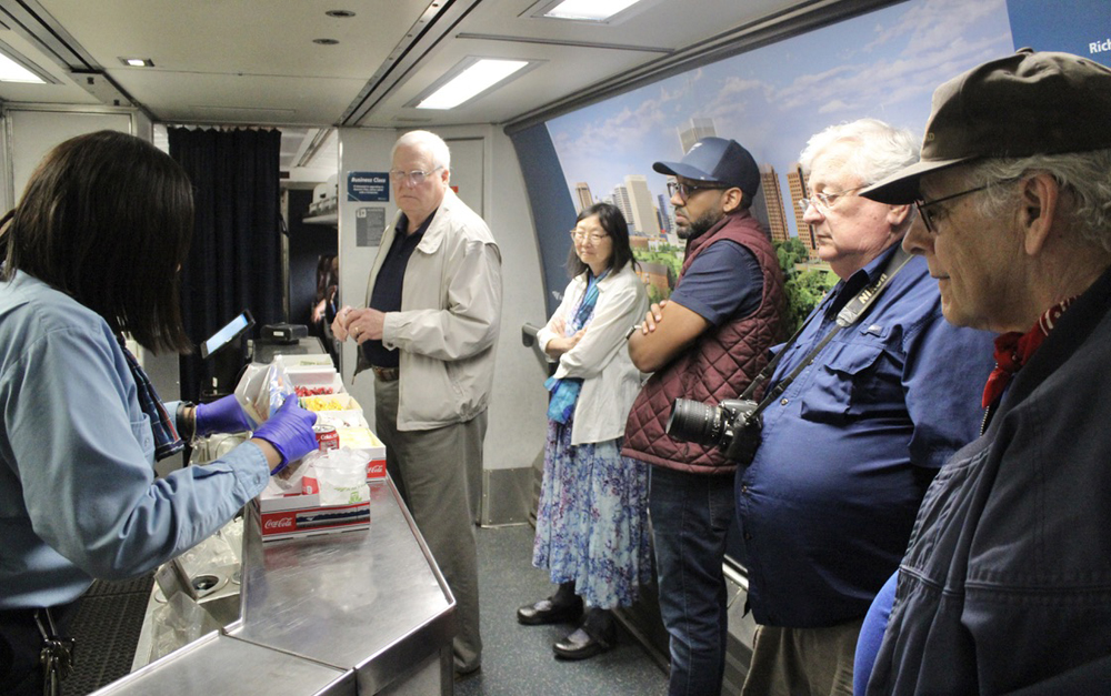 People wait for service in cafe car of passenger train