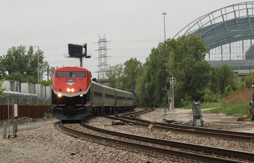 Passenger train with stadium in background