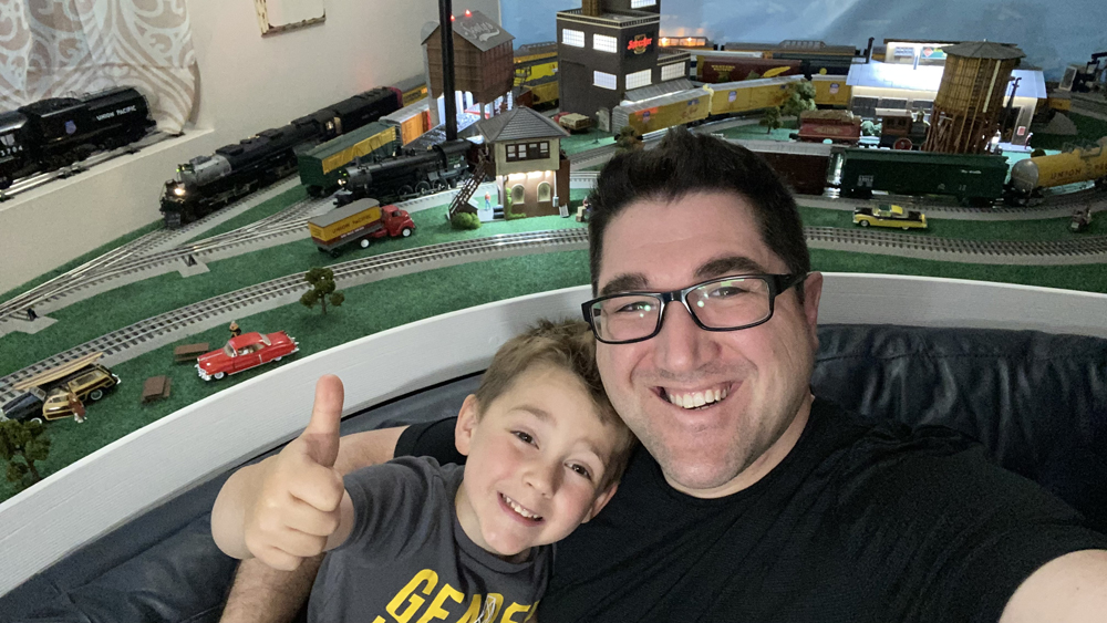 Man with boy giving thumbs up