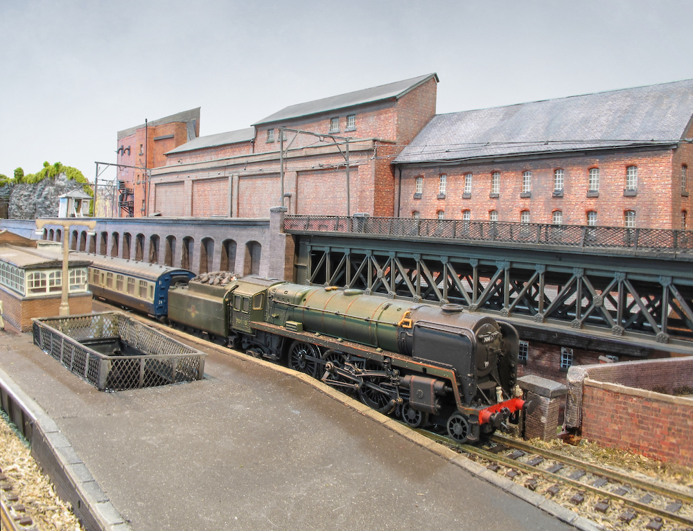 HO-scaled steam locomotive running on a layout.