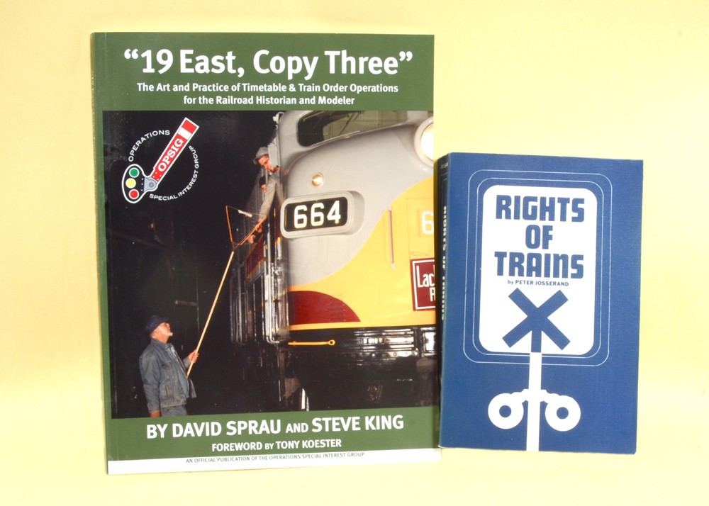 Color photo of two books on yellow background.