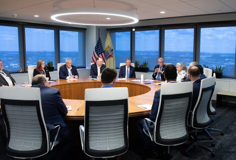 Large group of people meeting around circular table