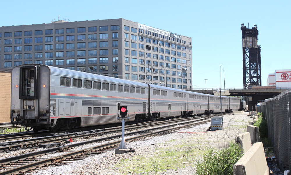 Going-away shot of passenger train with bilevel equipment.