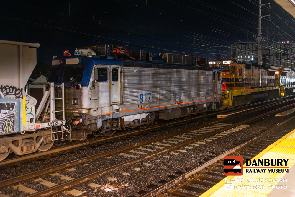 Electric locomotive being moved in freight train