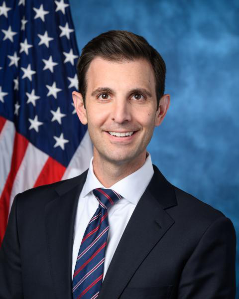 Portrait of man standing in front of American flag